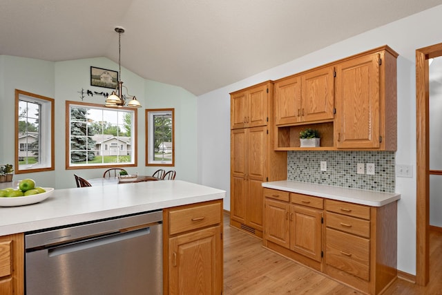 13019 Brookside Ln N, Rogers, MN 55374 - kitchen featuring stainless steel dishwasher, light wood-style flooring, light countertops, decorative backsplash, and lofted ceiling