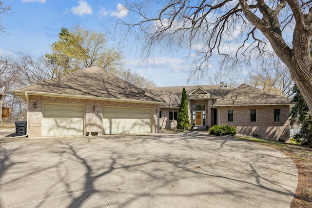 1181 12th Ave NW, New Brighton, MN 55112 - view of front of house featuring brick siding, concrete driveway, an attached garage, and roof with shingles