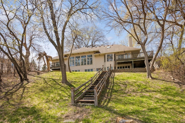 1181 12th Ave NW, New Brighton, MN 55112 - rear view of house with a chimney, a wooden deck, a yard, and stairway