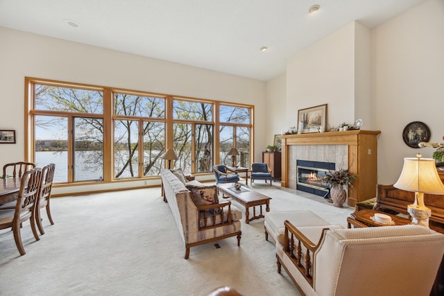 1181 12th Ave NW, New Brighton, MN 55112 - living room with light colored carpet, a fireplace, high vaulted ceiling, and a water view