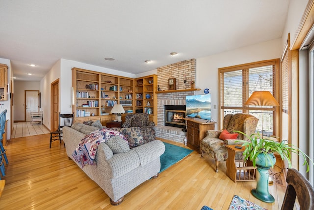 1181 12th Ave NW, New Brighton, MN 55112 - living room featuring light wood finished floors, a fireplace, and recessed lighting