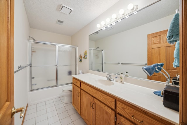 1181 12th Ave NW, New Brighton, MN 55112 - full bath with vanity, enclosed tub / shower combo, tile patterned floors, and a textured ceiling