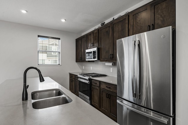 8698 London Cir NE Unit C, Blaine, MN 55449 - kitchen with stainless steel appliances, dark brown cabinetry, tasteful backsplash, light countertops, and recessed lighting