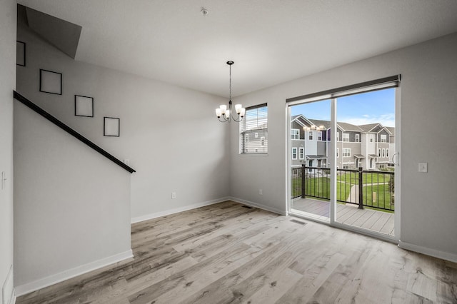 8698 London Cir NE Unit C, Blaine, MN 55449 - unfurnished dining area with a chandelier and wood finished floors