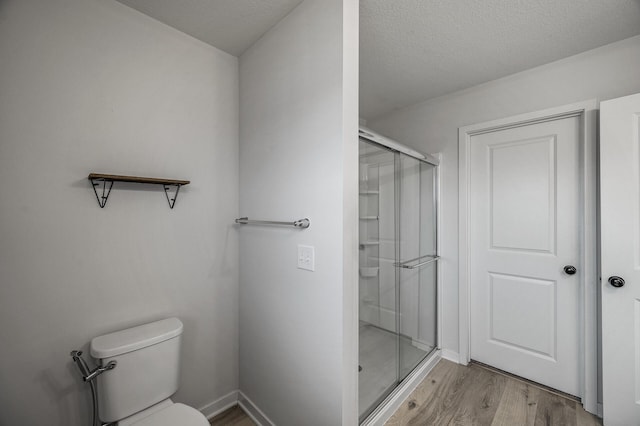 8698 London Cir NE Unit C, Blaine, MN 55449 - full bath featuring a shower stall, wood finished floors, and a textured ceiling
