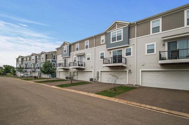 8698 London Cir NE Unit C, Blaine, MN 55449 - view of property featuring a residential view, a garage, and driveway