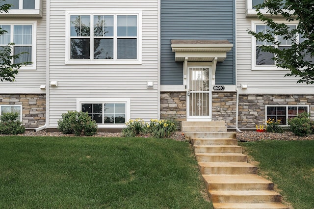 8698 London Cir NE Unit C, Blaine, MN 55449 - doorway to property with stone siding and a yard
