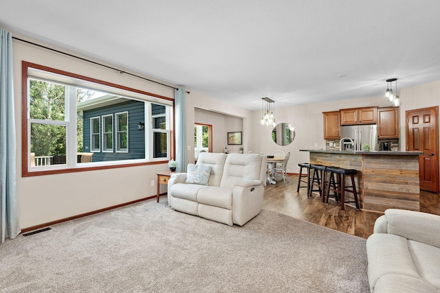 11608 21st St NE, Saint Michael, MN 55376 - carpeted living area with healthy amount of natural light and a chandelier