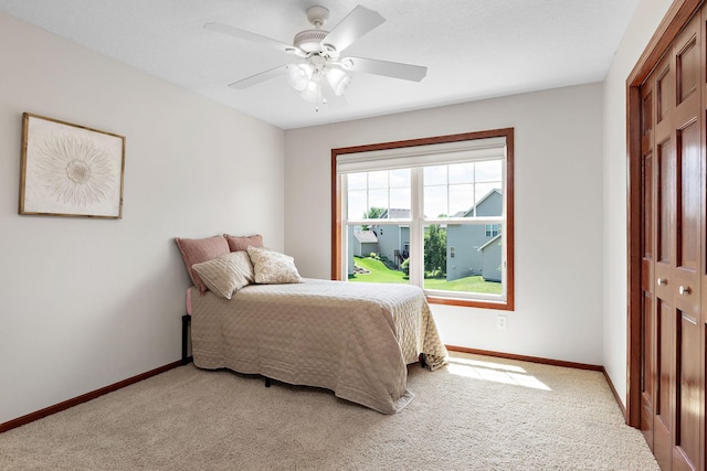 11608 21st St NE, Saint Michael, MN 55376 - bedroom with light colored carpet, a closet, and ceiling fan