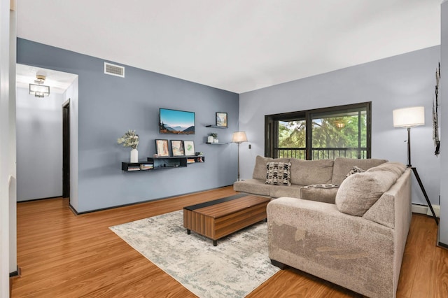 2265 Youngman Ave Unit 207E, Saint Paul, MN 55116 - living room featuring wood finished floors and a baseboard heating unit