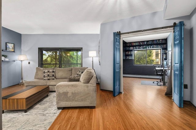2265 Youngman Ave Unit 207E, Saint Paul, MN 55116 - living room with baseboard heating, wood finished floors, and plenty of natural light