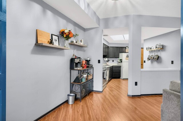 2265 Youngman Ave Unit 207E, Saint Paul, MN 55116 - bar area with freestanding refrigerator, light wood-style flooring, and stainless steel electric stove