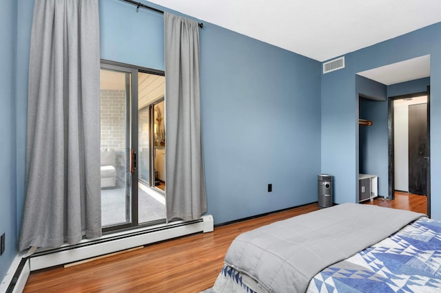 2265 Youngman Ave Unit 207E, Saint Paul, MN 55116 - bedroom featuring baseboard heating and wood finished floors