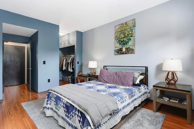 2265 Youngman Ave Unit 207E, Saint Paul, MN 55116 - bedroom featuring wood finished floors and a walk in closet