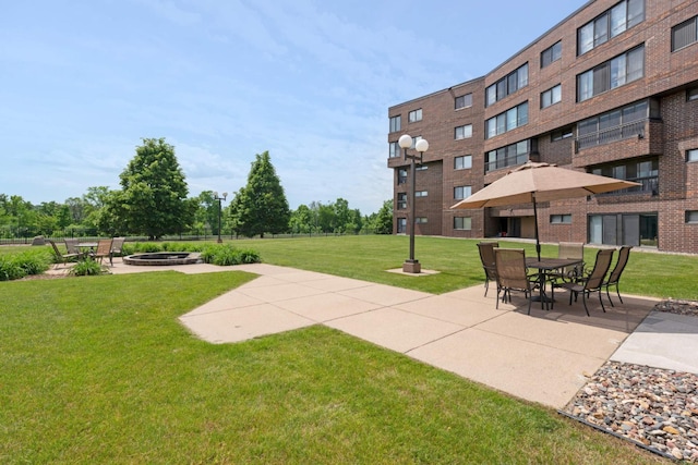 2265 Youngman Ave Unit 207E, Saint Paul, MN 55116 - view of green lawn with a patio and an outdoor fire pit