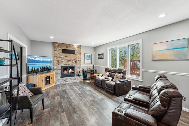 8700 Kilbirnie Ter, Brooklyn Park, MN 55443 - living room with wood finished floors, a brick fireplace, and recessed lighting