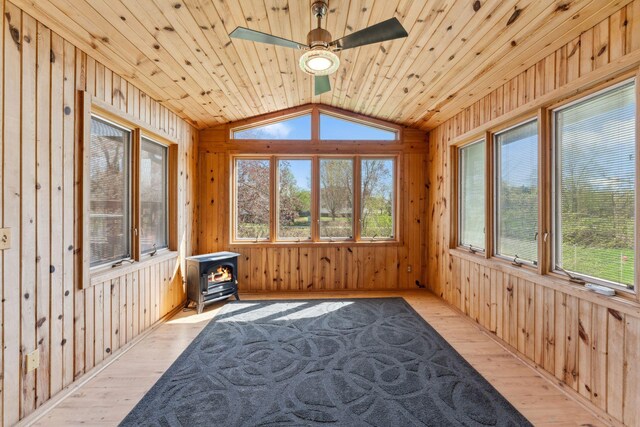 8700 Kilbirnie Ter, Brooklyn Park, MN 55443 - unfurnished sunroom with a wood stove and vaulted ceiling