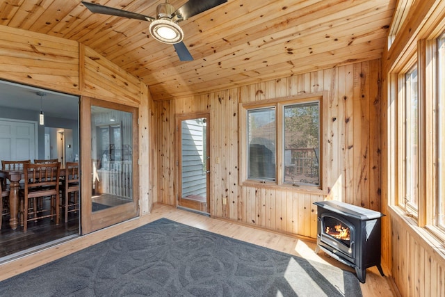 8700 Kilbirnie Ter, Brooklyn Park, MN 55443 - unfurnished sunroom with lofted ceiling and a wood stove