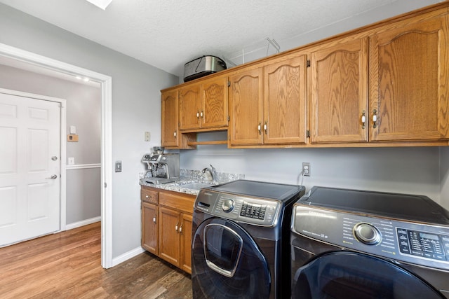 8700 Kilbirnie Ter, Brooklyn Park, MN 55443 - laundry area with washer and dryer, dark wood finished floors, cabinet space, and a textured ceiling