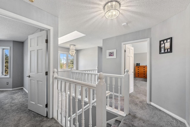 8700 Kilbirnie Ter, Brooklyn Park, MN 55443 - hall featuring an upstairs landing, carpet flooring, a chandelier, and a textured ceiling