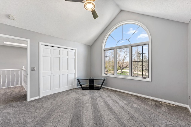 8700 Kilbirnie Ter, Brooklyn Park, MN 55443 - unfurnished bedroom featuring carpet floors, lofted ceiling, ceiling fan, a closet, and a textured ceiling