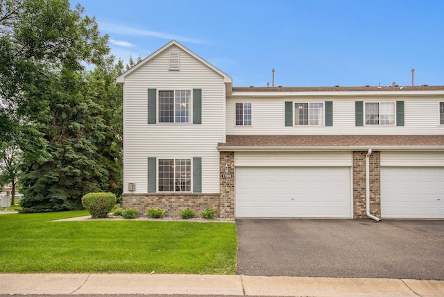 17980 69th Pl N, Maple Grove, MN 55311 - view of front of home featuring brick siding, a front lawn, asphalt driveway, a garage, and a shingled roof