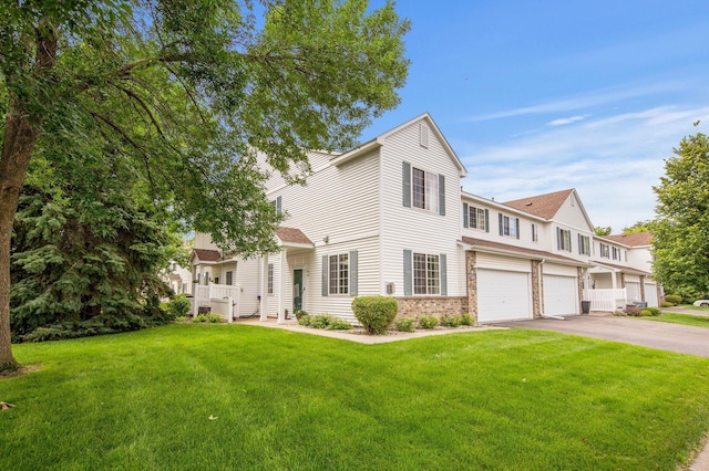 17980 69th Pl N, Maple Grove, MN 55311 - view of front of home with driveway, an attached garage, a front yard, and brick siding