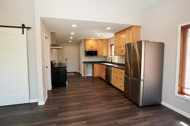 1722 41st Ave NE, Dovre Twp, MN 56201 - kitchen with appliances with stainless steel finishes, wall chimney range hood, light brown cabinetry, dark wood-type flooring, and dark countertops