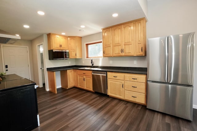1722 41st Ave NE, Dovre Twp, MN 56201 - kitchen featuring appliances with stainless steel finishes, light brown cabinetry, dark wood finished floors, dark countertops, and recessed lighting