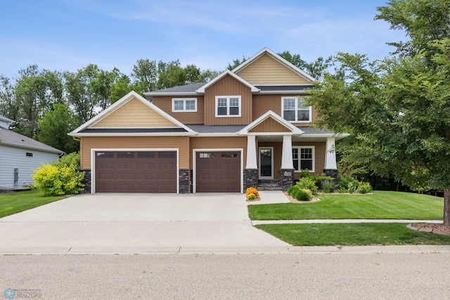 3702 Houkom Dr E, Fargo, ND 58078 - craftsman-style home featuring driveway, stone siding, a front yard, a garage, and board and batten siding