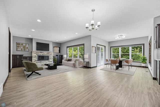 3702 Houkom Dr E, Fargo, ND 58078 - living area with light wood finished floors, a chandelier, a fireplace, and recessed lighting
