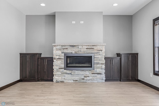3702 Houkom Dr E, Fargo, ND 58078 - unfurnished living room with light wood-style flooring, recessed lighting, and a stone fireplace