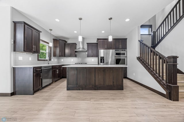 3702 Houkom Dr E, Fargo, ND 58078 - kitchen with stainless steel appliances, wall chimney range hood, dark brown cabinetry, light countertops, and decorative backsplash