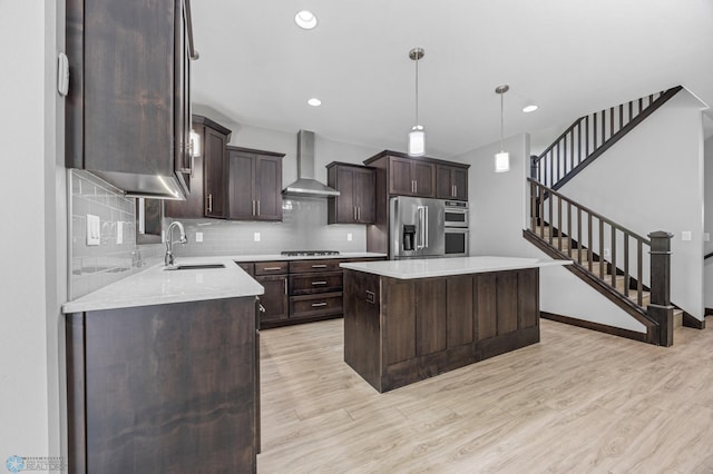 3702 Houkom Dr E, Fargo, ND 58078 - kitchen featuring wall chimney range hood, stainless steel appliances, light wood-style floors, dark brown cabinetry, and recessed lighting