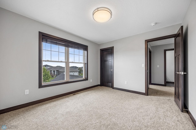3702 Houkom Dr E, Fargo, ND 58078 - unfurnished bedroom featuring carpet floors and baseboards
