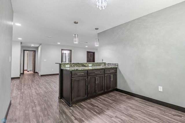 3702 Houkom Dr E, Fargo, ND 58078 - kitchen featuring a peninsula, dark wood finished floors, recessed lighting, dark brown cabinetry, and decorative light fixtures