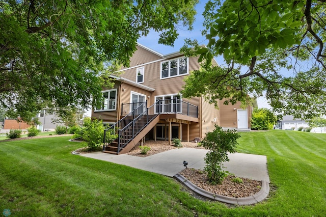 3702 Houkom Dr E, Fargo, ND 58078 - back of property with stairs, a wooden deck, and a lawn