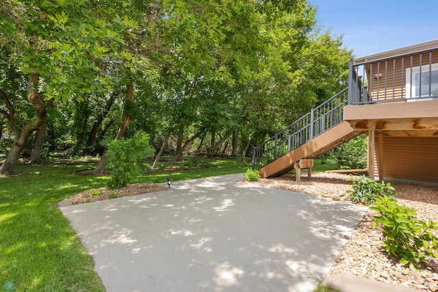 3702 Houkom Dr E, Fargo, ND 58078 - view of grassy yard with stairway and a patio