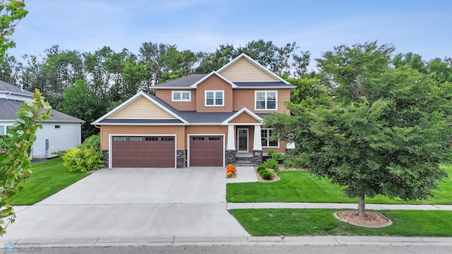 3702 Houkom Dr E, Fargo, ND 58078 - craftsman-style house featuring driveway, a front lawn, stone siding, and board and batten siding