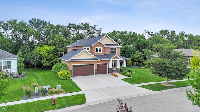 3702 Houkom Dr E, Fargo, ND 58078 - craftsman-style home with driveway, a front lawn, stone siding, and view of wooded area