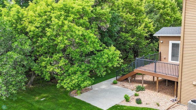 3702 Houkom Dr E, Fargo, ND 58078 - view of green lawn with a patio area, a wooden deck, and stairs