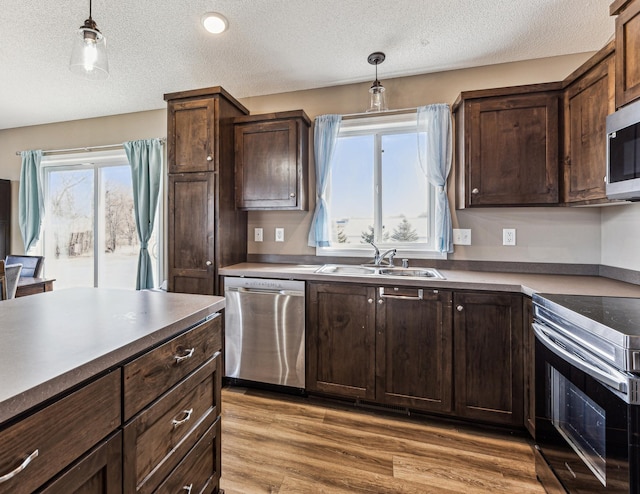 230 Newspaper Run NE, Kimball, MN 55353 - kitchen with appliances with stainless steel finishes, a textured ceiling, hanging light fixtures, and dark brown cabinetry