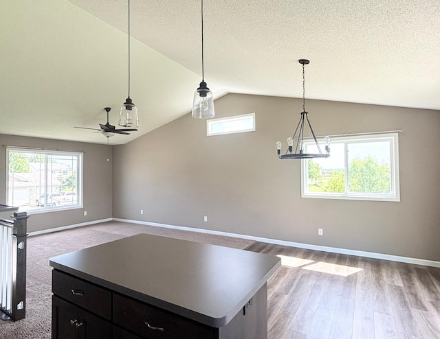 230 Newspaper Run NE, Kimball, MN 55353 - kitchen featuring a ceiling fan, healthy amount of natural light, dark cabinetry, lofted ceiling, and open floor plan