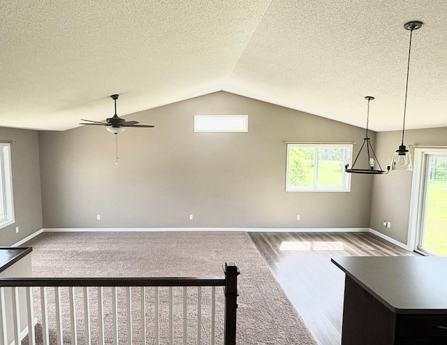 230 Newspaper Run NE, Kimball, MN 55353 - unfurnished living room with vaulted ceiling, wood finished floors, ceiling fan, plenty of natural light, and a chandelier