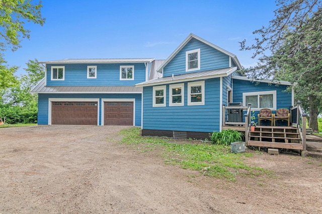 2565 Highland Rd, Minnetrista, MN 55359 - view of front facade featuring a metal roof, an attached garage, driveway, and a deck