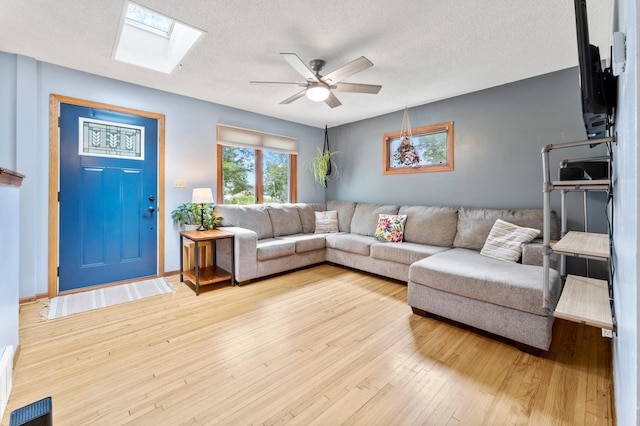 19172 Front Blvd NE, East Bethel, MN 55092 - living area with a ceiling fan, a skylight, wood finished floors, and a textured ceiling
