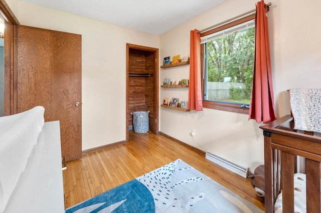 19172 Front Blvd NE, East Bethel, MN 55092 - bedroom featuring a baseboard radiator and wood finished floors