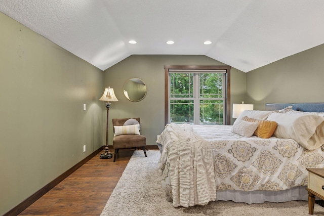 98 Tribute Ave, Hudson, WI 54016 - bedroom with vaulted ceiling, dark wood-style flooring, and recessed lighting