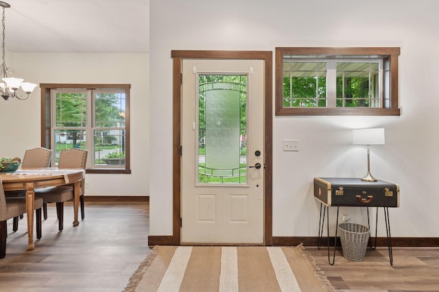 98 Tribute Ave, Hudson, WI 54016 - entryway with a chandelier, wood finished floors, and healthy amount of natural light