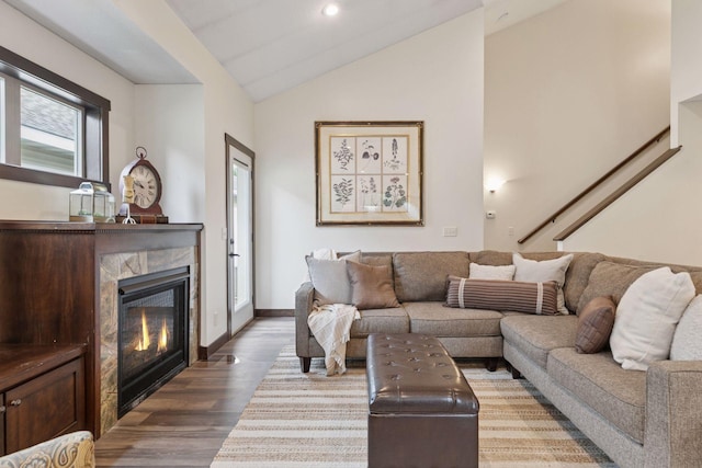 98 Tribute Ave, Hudson, WI 54016 - living area with vaulted ceiling, wood finished floors, a high end fireplace, stairs, and recessed lighting